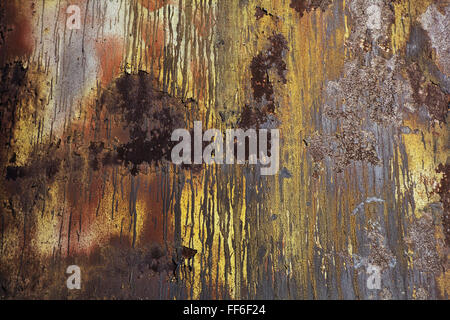 A wall with paint drips and marks and rust stains on metal. Stock Photo