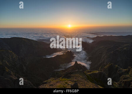 View from Pico do Ariero on sunrise over rugged valleys and deep canyons of the north coast of Madeira covered with clouds Stock Photo