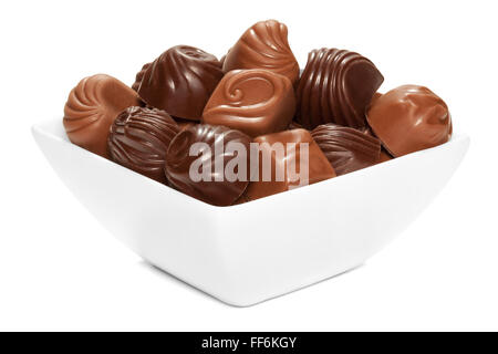 Chocolate sweets in white bowl, isolated on the white background, clipping path included. Stock Photo