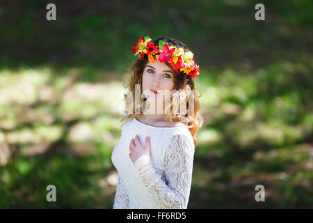 Portrait of a beautiful girl with flowers in her hair at spring time Stock Photo