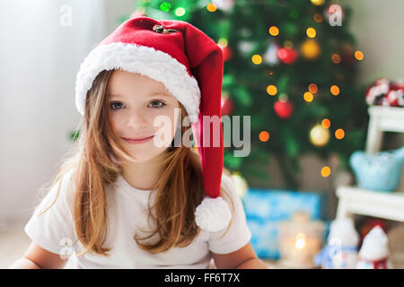 Beautiful Christmas close portrait of little preschool girl at home, dreaming Stock Photo