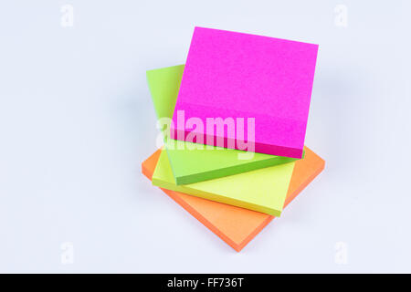 Four colored sticky notes staked on top of each other Stock Photo