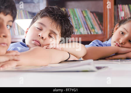 Asia Asian Asians Bookshelves Chin on Hands Clothing Creative Idea Examinations Hand on Chin Hands on Chin Head and Shoulders Stock Photo