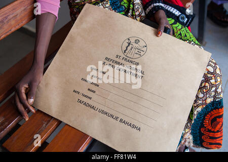 A patient waits with her x-ray, at St. Francis Hospital, Ifakara, Tanzania. Stock Photo