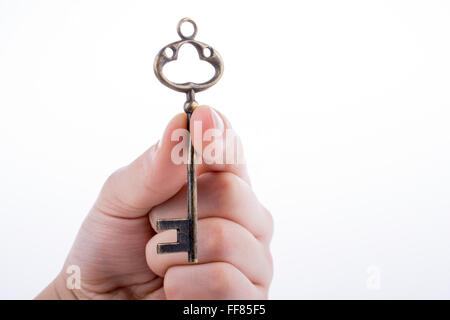 Hand holding a retro styled key Stock Photo