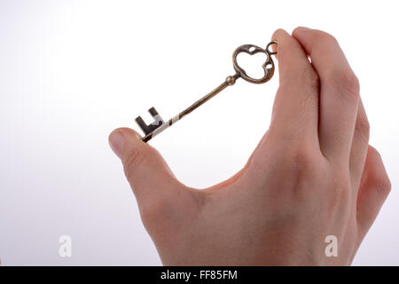 Hand holding a retro styled key Stock Photo