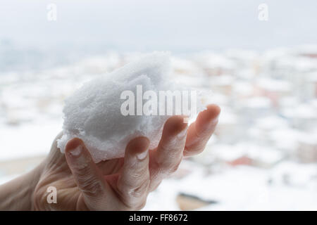 Snow In Hand Snow in hand hand with winter related background Stock Photo - Alamy