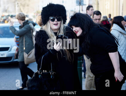 Brighton, UK. 11th February, 2016. This couple of fashionable ladies are dressed to stay warm as the weather turns colder in Brighton today as they attended the University of Brighton Graduation Ceremony held in The Dome . The forecast is for colder weather to spread across Britain with snow predicted for next week  Credit:  Simon Dack/Ģ����ý Live News Stock Photo