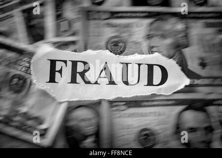 Fraud concept. Torn piece of paper with the word 'Fraud' on dollar bills. Motion blur. Black and White. Closeup. Stock Photo