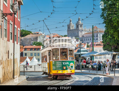 Tram 28 at Largo das Portas do Sol, with Sao Vicente de Fora Church in the background, Lisbon, Portugal Stock Photo