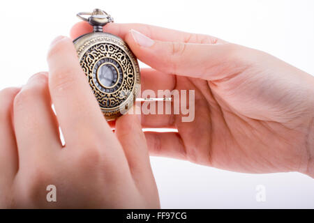 Hand holding a retro styled pocket watch in hand Stock Photo