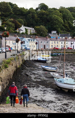 Two fishermen, Lower Fishguard Harbour, Pembrokeshire, Wales, UK GB Stock Photo