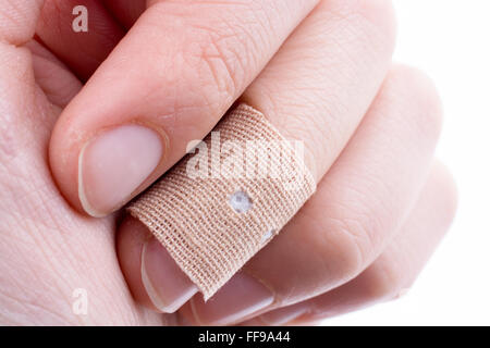 finger in white bandage on a white background Stock Photo