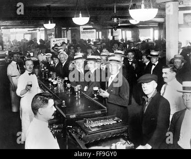 Prohibition, USA. Interior of a crowded bar moments before midnight on June 30, 1919, when prohibition went into effect, New York City, NY, USA. Stock Photo