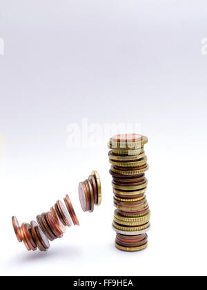 pile of Euro coins falling or collapsing Stock Photo