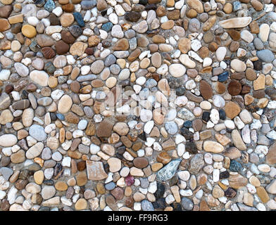Colorful exposed aggregate concrete with gray, brown and blues pebbles in close-up Stock Photo