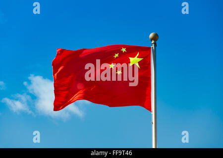 Chinese national flag with blue sky as background Stock Photo