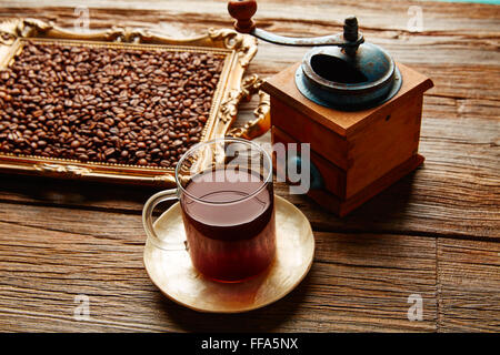 Coffee cup with vintage grinder on wooden old table Stock Photo