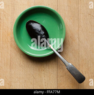 Black tamarind past on spoon Stock Photo