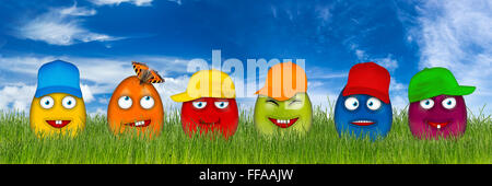 colorful easter eggs with funny faces isolated in front of blue sky Stock Photo