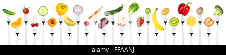 set of tasty fruits and vegetables on forks isolated on white background Stock Photo