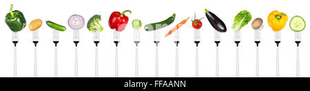 set of tasty vegetables on forks isolated on white background Stock Photo