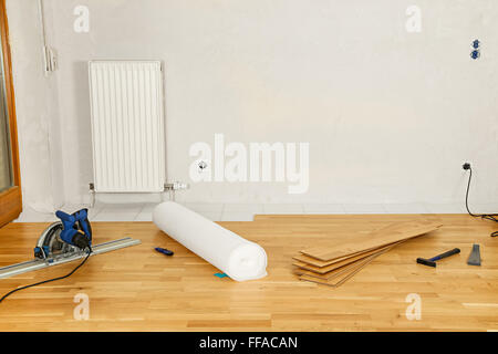 empty flat with parquet flooring and tools Stock Photo