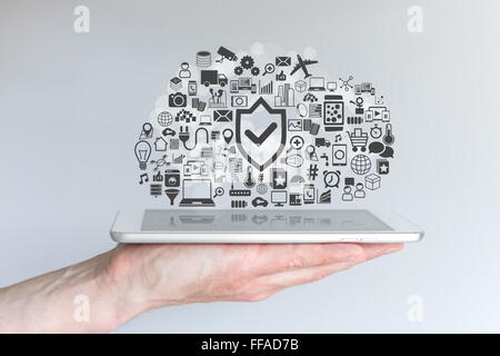 Cloud computing security concept with male hand holding tablet Stock Photo