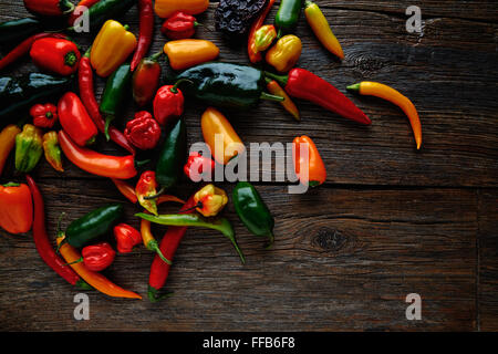 Mexican hot chili peppers colorful mix habanero poblano serrano jalapeno on wood Stock Photo