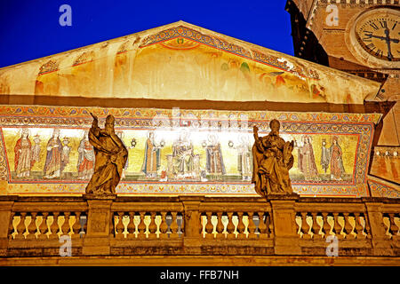 Santa Maria in Trastevere with its gold mosaics lighting up at night in Rome. Stock Photo