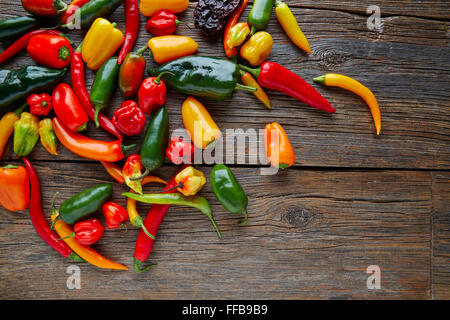Mexican hot chili peppers colorful mix habanero poblano serrano jalapeno on wood Stock Photo