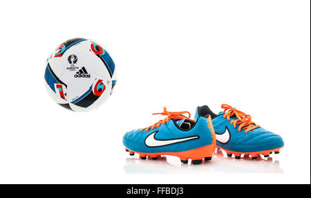 Adidas BEAU JEU 2016 Euro football with A Pair of Nike Football Boots on a White Background Stock Photo