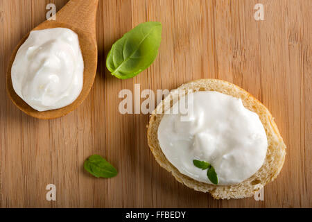 Healthy Organic Whole Grain bread and one spoon with Cream Cheese Stock Photo