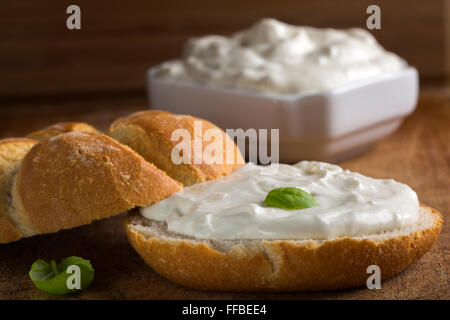 Healthy Organic Whole Grain Bagel with Cream Cheese over wooden background Stock Photo