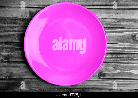 Empty pink plate on wooden table Stock Photo