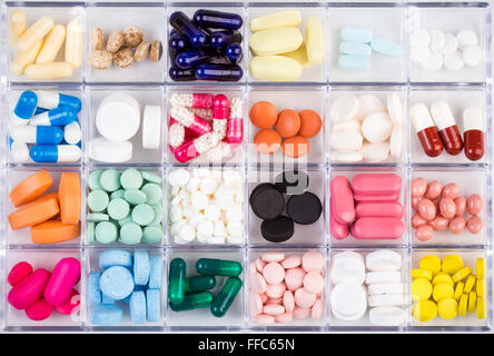 Various medicine pills and capsules in plastic container Stock Photo