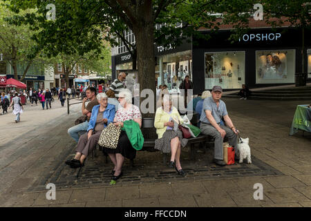 People having a rest on a bench, Norwich, Norfolk, UK Stock Photo