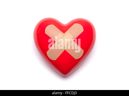 Red heart with adhesive plaster on white background Stock Photo