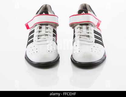 Adidas Olympic weightlifting shoes on a white background with a reflection. Stock Photo