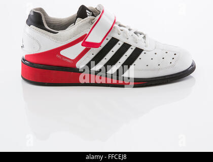 Adidas Olympic weightlifting shoes on a white background with a reflection. Stock Photo