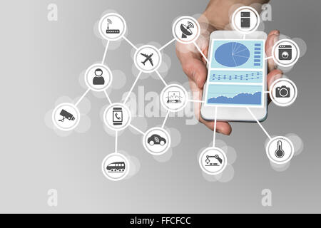 Hand holding modern smart phone on neutral background. Dashboard in order to monitor and control internet of things Stock Photo
