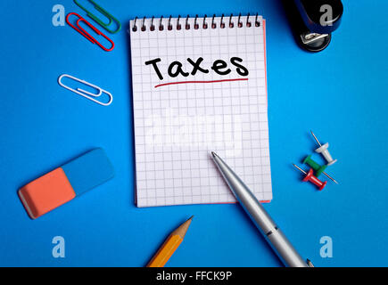 Taxes word on notebook page Stock Photo