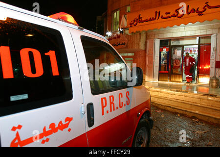 Between calls the paramedics pick up water supplies from a local shop in Aizaria north of Jerusalem. Médecins Du Monde (MDM) and the Palestine Red Crescent Society (PRCS) have set up emergency medical transport and community first aid training in the West Bank since the Wall was built and has cut off easy access to Jerusalem hospitals. Stock Photo