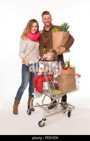 Happy couple and baby in shopping cart Stock Photo