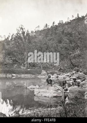 APACHE SCOUTS, 1873. /nThree Apache scouts on Apache Lake, Sierra Blanca (White) Mountain Range, Arizona. Photograph by Timothy O'Sullivan, 1873. Stock Photo