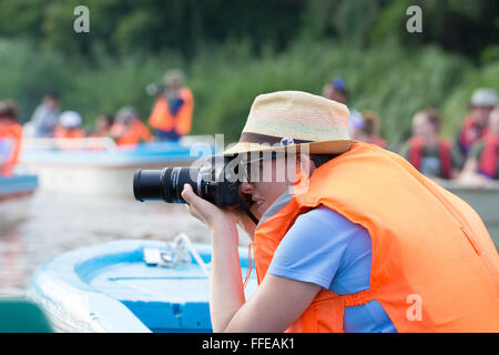 Tourists watching wildlife from boats on the Kinabatangan River, Sabah, Malaysia Stock Photo