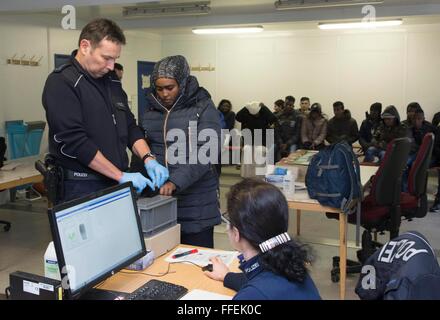 German police take a fingerprint scan of a migrant during his registration at the German Federal Police in Rosenheim, 05 February 2016. Stock Photo