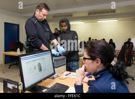 German police take a fingerprint scan of a migrant during his registration at the German Federal Police in Rosenheim, 05 February 2016. Stock Photo