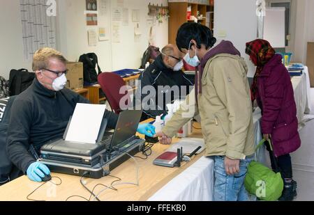 German police take a fingerprint scan of a migrant during his registration the German Federal Police in Rosenheim, 05 February 2016. Stock Photo