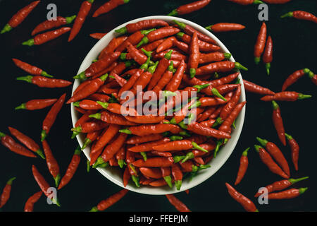 Red pepper in bowl on black background. Stock Photo